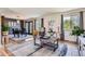 Cozy living room featuring hardwood floors and natural light from the large windows at 6477 W Clifton Pl, Littleton, CO 80128