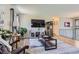 Inviting living room with modern accents, TV, and a view to the entryway at 6477 W Clifton Pl, Littleton, CO 80128