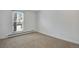 This bedroom has neutral carpet and a large window with blinds at 8050 Niwot Rd # 40, Niwot, CO 80503