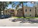 Two-story condo buildings featuring balconies, wooden fences, and assigned parking with mature trees at 8050 Niwot Rd # 40, Niwot, CO 80503