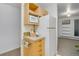 Cozy kitchen nook with microwave, refrigerator, and drawers adjacent to living area at 8050 Niwot Rd # 40, Niwot, CO 80503