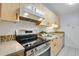 Well-maintained kitchen featuring wooden cabinets, stainless steel appliances, and mosaic backsplash at 8050 Niwot Rd # 40, Niwot, CO 80503