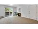 Bright living room with balcony, fireplace, and large carpeted area; plants accent the space at 8050 Niwot Rd # 40, Niwot, CO 80503
