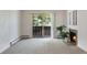 Carpeted living room with fireplace, sliding glass doors to balcony, and bright natural light at 8050 Niwot Rd # 40, Niwot, CO 80503