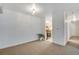 Spacious carpeted living room with view into the kitchen and a hallway, bright and open at 8050 Niwot Rd # 40, Niwot, CO 80503