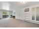 Bright, carpeted living room with a fireplace, a balcony, and built in shelving with an AC unit at 8050 Niwot Rd # 40, Niwot, CO 80503