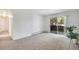 Spacious carpeted living room with sliding glass doors to a balcony allowing abundant natural light at 8050 Niwot Rd # 40, Niwot, CO 80503