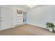 Carpeted room featuring a wall unit with an AC unit and built-in shelves, and a plant at 8050 Niwot Rd # 40, Niwot, CO 80503