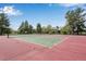 A full tennis court with green trees and blue skies in the background at 8050 Niwot Rd # 40, Niwot, CO 80503