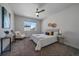 Cozy bedroom featuring neutral decor, a ceiling fan, and ample natural light at 574 E Hinsdale Ave, Littleton, CO 80122