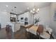 Bright, modern kitchen with white cabinets, stainless appliances, and an adjacent dining area at 574 E Hinsdale Ave, Littleton, CO 80122