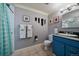 Bright bathroom with blue vanity and colorful decorations at 5270 Tabor St, Arvada, CO 80002