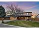 Inviting two-story home showcasing a well-manicured lawn and mature trees at 5270 Tabor St, Arvada, CO 80002