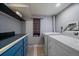 Laundry room with front loading washer and dryer, counter space and overhead storage at 5270 Tabor St, Arvada, CO 80002