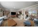 Open concept living room with bar seating, wood accents, and seamless flow to dining area at 5270 Tabor St, Arvada, CO 80002