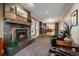Inviting living room with fireplace, and an open view to the modern kitchen at 5270 Tabor St, Arvada, CO 80002