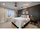 Bright bedroom with dark accent wall, natural light, and modern lighting at 5270 Tabor St, Arvada, CO 80002