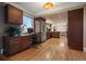 Modern office space featuring custom cabinets, built-in desk, and an open layout to the kitchen at 5270 Tabor St, Arvada, CO 80002