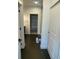Hallway bathroom featuring dark floors, a blue mat, and a shower through the doorway at 9642 E Idaho Pl, Aurora, CO 80247