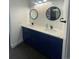 Stylish bathroom featuring double sinks with quartz countertops and navy-blue cabinetry at 9642 E Idaho Pl, Aurora, CO 80247