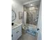 Stylish bathroom with a marble-tiled shower, modern vanity, and chic decor at 9642 E Idaho Pl, Aurora, CO 80247