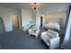 Spacious bedroom featuring stylish decor, plush seating, and abundant natural light at 9642 E Idaho Pl, Aurora, CO 80247