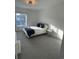 Bright bedroom featuring a plush bed, modern lighting, and a large window with neighborhood views at 9642 E Idaho Pl, Aurora, CO 80247