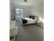 Bright bedroom featuring a plush bed, modern lighting, and a large window with neighborhood views at 9642 E Idaho Pl, Aurora, CO 80247