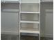 Walk-in closet with white shelving and neutral colored carpeting at 9642 E Idaho Pl, Aurora, CO 80247