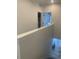 Upstairs hallway with railing overlooking dining area and doorway access to laundry room at 9642 E Idaho Pl, Aurora, CO 80247