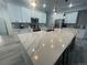 Eat-in kitchen with large island, stainless appliances and modern pendant lighting at 9642 E Idaho Pl, Aurora, CO 80247