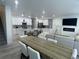 Open concept eat-in kitchen, dining and living room area with neutral decor at 9642 E Idaho Pl, Aurora, CO 80247