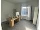 Bright home office with large window, modern desk, and ample workspace at 9642 E Idaho Pl, Aurora, CO 80247