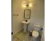 Small powder room with pedestal sink, black framed mirror, and checkerboard rug at 9642 E Idaho Pl, Aurora, CO 80247