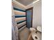 Updated bathroom with unique striped wall and penny tile at 3335 Dexter St, Denver, CO 80207