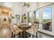 Dining area showcasing deck access, stunning views, and modern chandelier at 3630 Mesa Verde Rd, Monument, CO 80132