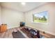 Bright exercise room with wood look flooring, workout equipment, and views of the outdoors at 3630 Mesa Verde Rd, Monument, CO 80132