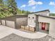 Modern home with three-car garage, stone accents, and outdoor seating area at 3630 Mesa Verde Rd, Monument, CO 80132