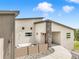 Modern home with stone accents, stylish privacy features, and a vibrant red front door at 3630 Mesa Verde Rd, Monument, CO 80132