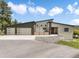 Modern home exterior with a stylish facade, three-car garage, and a vibrant red front door at 3630 Mesa Verde Rd, Monument, CO 80132