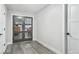 Hallway featuring wood-look flooring and a stylish grey door with glass panels at 3630 Mesa Verde Rd, Monument, CO 80132