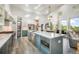 Bright, open kitchen with a marble island, stainless steel appliances, and seamless integration with the living area at 3630 Mesa Verde Rd, Monument, CO 80132