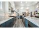 Spacious kitchen featuring marble countertops, a stainless steel refrigerator, and custom blue and white cabinetry at 3630 Mesa Verde Rd, Monument, CO 80132