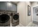 Laundry room featuring updated cabinets, black stainless steel appliances and tile floor at 3630 Mesa Verde Rd, Monument, CO 80132