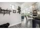 Bright living room with high ceilings, wood floors, stone fireplace, and open layout leading to the kitchen and outdoor views at 3630 Mesa Verde Rd, Monument, CO 80132