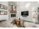 Modern living room with a stone fireplace, a large television, and cozy furniture with access to the kitchen at 3630 Mesa Verde Rd, Monument, CO 80132