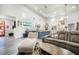 Bright and open living room with vaulted ceiling, modern lighting and colorful art at 3630 Mesa Verde Rd, Monument, CO 80132
