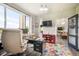 Well-lit office with large windows offering scenic views and a colorful rug at 3630 Mesa Verde Rd, Monument, CO 80132