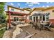 Outdoor patio showcasing a pergola, a dining set, lounge furniture, and a cozy fire pit for entertaining guests at 2400 S Clayton St, Denver, CO 80210