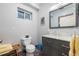 Bathroom featuring a toilet, vanity with a marble countertop, and a framed mirror at 2400 S Clayton St, Denver, CO 80210